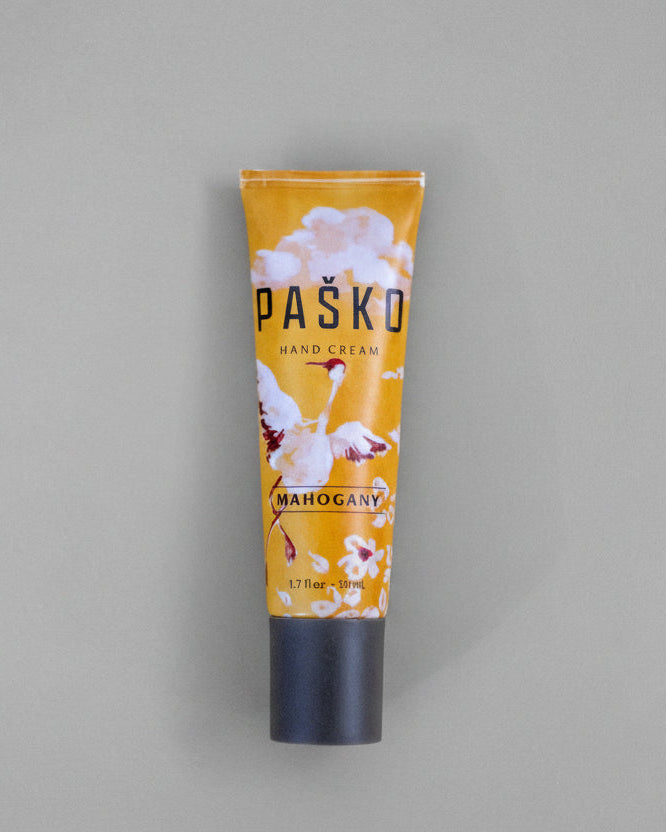 Tube of Pasko hand cream on a gray background