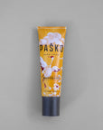 Tube of Pasko hand cream on a gray background