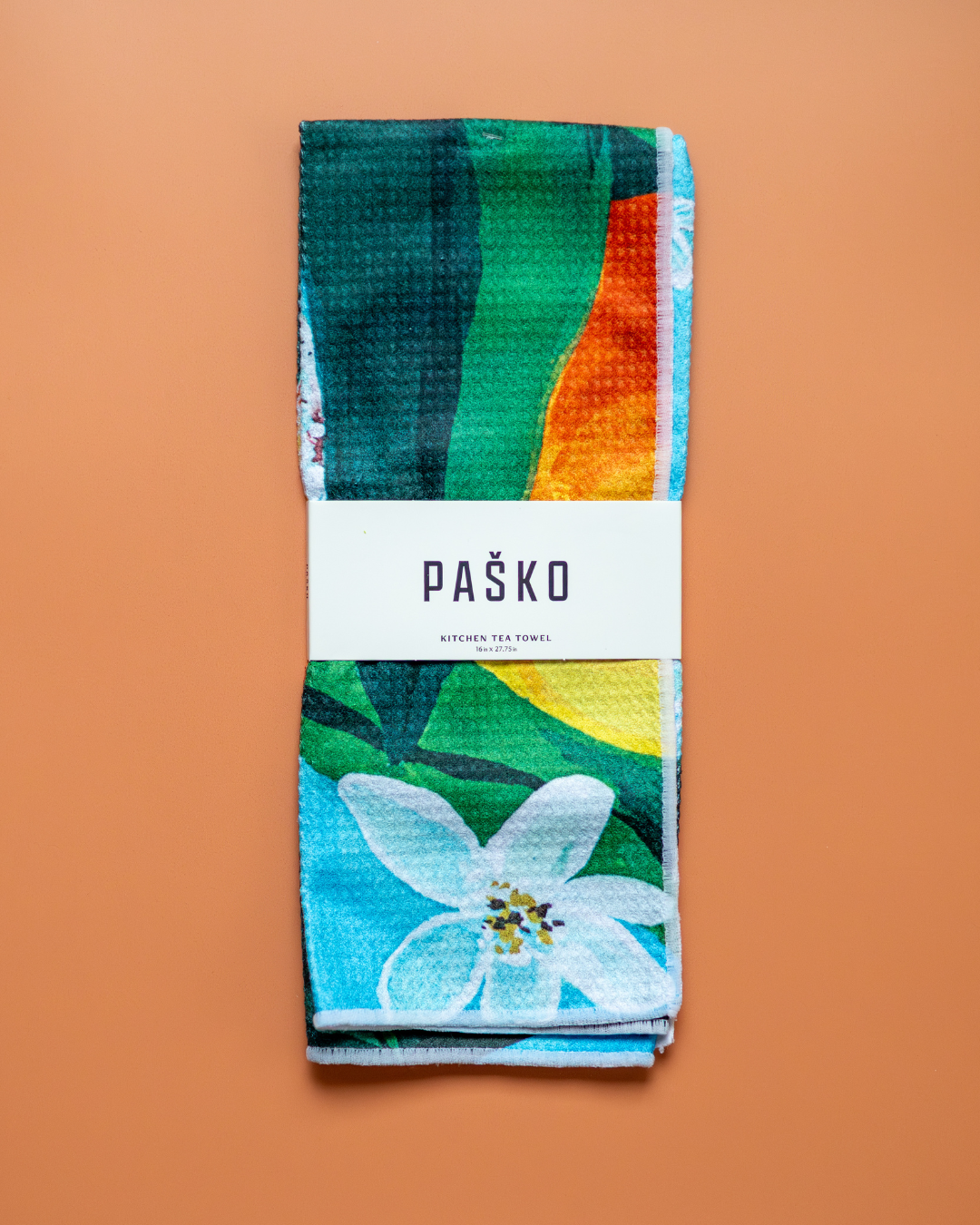 Paško kitchen tea towel with floral design on a brown background