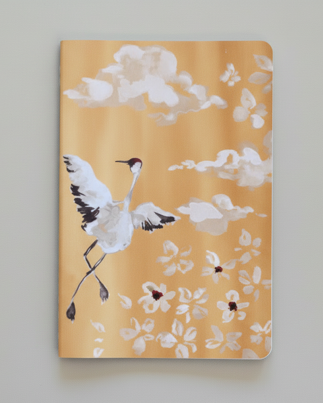Notebook with crane and floral design on a gray background