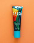 Pasko Valencia hand cream tube on an orange background