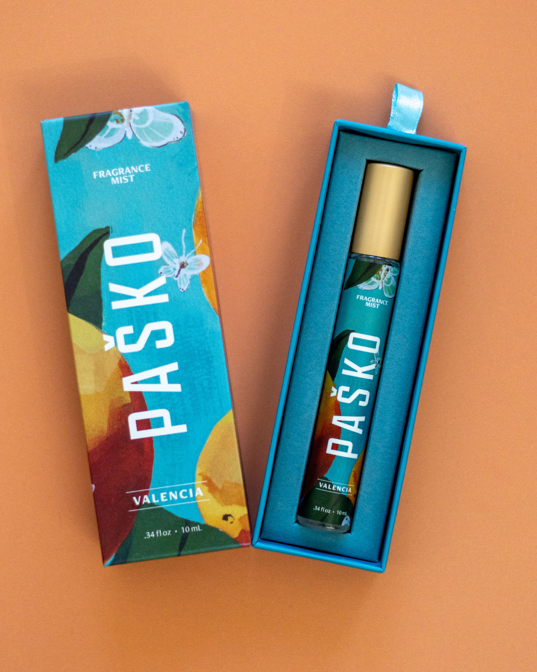 Paøko Valencia perfume bottle and packaging on an orange background